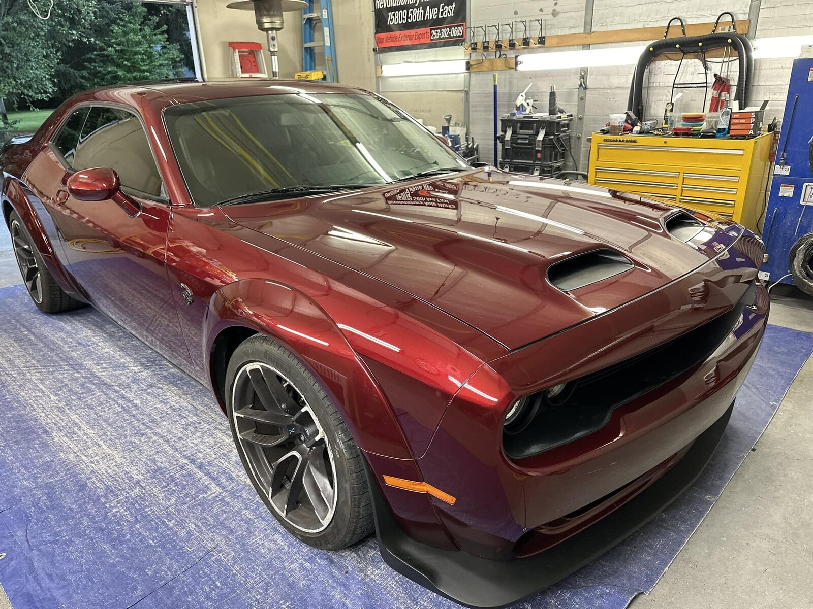 Red Dodge Challenger after passenger fender and front bumper repair