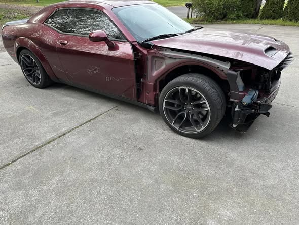 Red Dodge Challenger before passenger fender and front bumper repair
